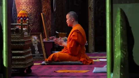 Buddhist monk with orange robe pray in temple Luang Prabang Laos Stock Footage 74684313