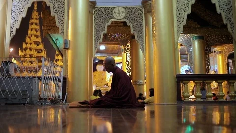 Buddhist monk praying alone inside shwedagon temple in Yangon, Myanmar Video stock 114379265