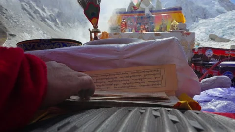 Buddhist monk in red robe sit in shrine, read sacred lettering sheets, praying Stock Footage 167418828
