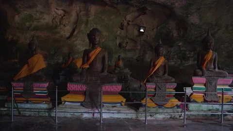 Buddhist monk statues sitting on an altar, wind blowing robes 4k Stock Footage 126791156