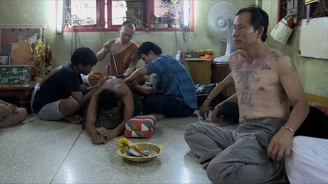 Buddhist monk tattooing a man Stock Footage 103451070
