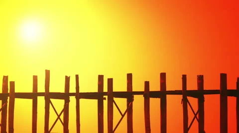 Buddhist monk walking across U Bein Bridge at sunset. Amarapura, Myanmar Video stock 48306839