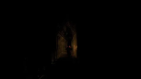 Buddhist monk walking in a dark temple corridor 库存影片 331950937