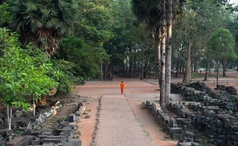 Buddhist monk walking on a pathway Stock Photos