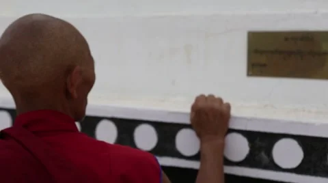 Buddhist Monk Walking by Prayer Flags and Stupas.mp4 Video stock 47594191