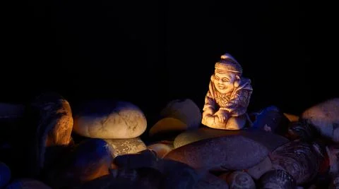 Buddhist monk warming himself by the fire at night Stock Photos