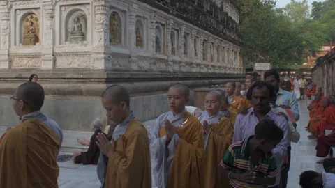 Buddhist monks, apprentice monks and visitors circumambulate main temple 库存影片 290308187