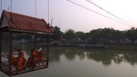 Buddhist Monks in a cable car crossing the Chao Phraya River Stock Footage 129194445