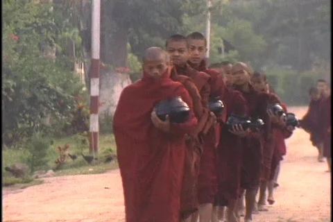 Buddhist monks collect alms in the morning. Stock Footage