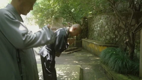 Buddhist monks performing a religious ritual in a temple garden Stock Footage 340563344