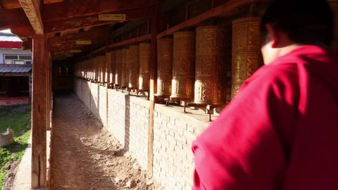 Buddhist monks turning the prayer wheels, Eastern Tibet, China Stock Footage 100074155