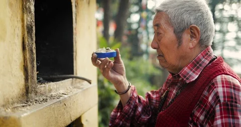Buddhist old man Burning Incense Sticks, Dharamsala, India Stock Footage 119132994