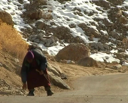 Buddhist pilgrim sweeping the road Stock Footage 401115
