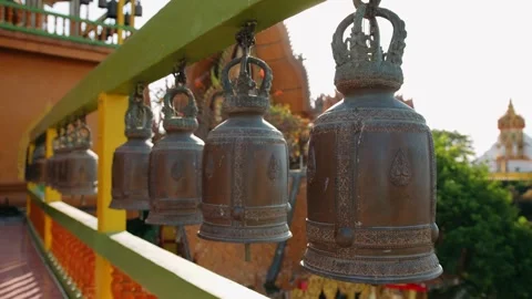 Buddhist prayer bells hanging in a row at a wat tham sua temple, Kanchanaburi Stock Footage 322518908