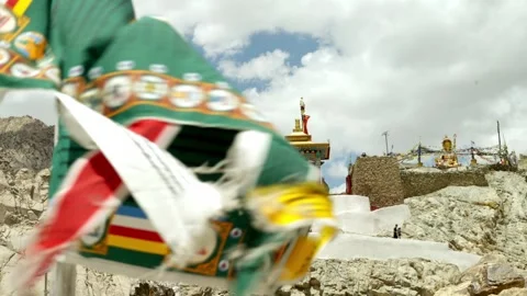 Buddhist prayer flag flies in front of Temple in remote Himalayas Stock Footage 282525921