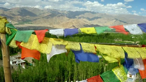 Buddhist prayer flags flutter over mountains and lush valley Stock Footage 282525823