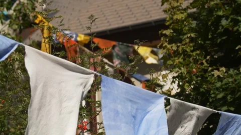 Buddhist prayer flags flutter in the wind, mountain chalet, eco farm, commune Video stock 155305991