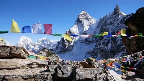 Buddhist prayer flags flying in strong wind on peak of Renjo La pass, Nepal Stock Footage 146068734