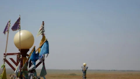 Buddhist prayer flags gently moving in the wind with vast empty steppe in bac Stock Footage 78531967