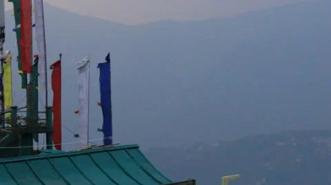 Buddhist prayer flags moving in the wind in front of misty hills. Stock Footage 37563535
