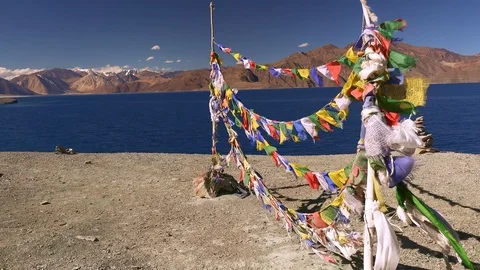 Buddhist prayer flags at Pangong Tso lake and Himalaya mountains. Ladakh, India Video stock 89023061