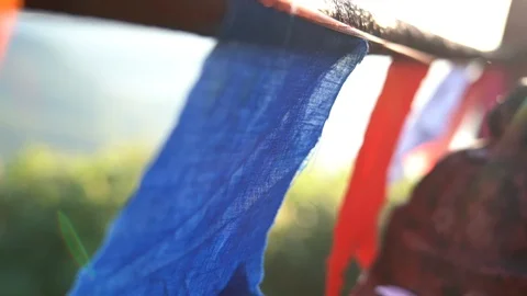 Buddhist prayer flags swaying in the wind at sunrise. Stock Footage 89482352