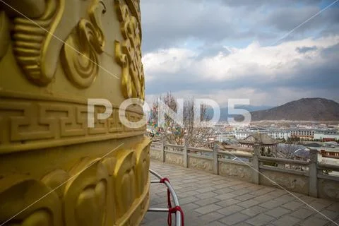 Buddhist Prayer Wheel and Prayer Flags in Shangri-La, China Stock Photos