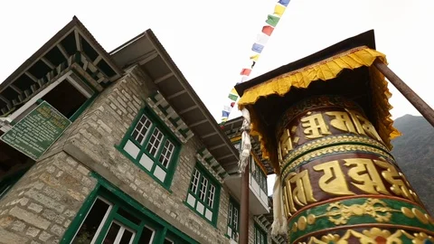Buddhist prayer wheel in Nepal with flags and mountain in background Stock-Footage 101442735
