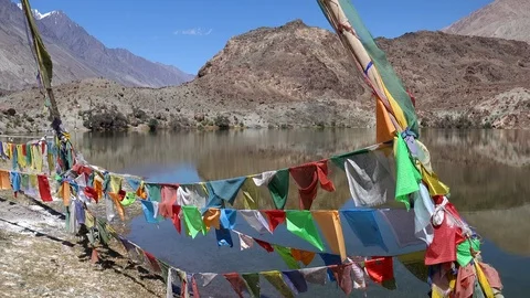 Buddhist praying flags. Tso Yarab sacred lake. Himalaya mountains, Ladakh, India Stock Footage 112810661