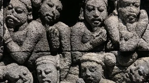 Buddhist scriptures adorning stone facades of Borobudur temple. Java Indonesia Stock Footage 74395356