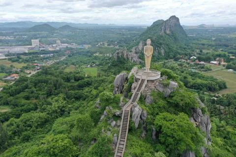 Buddhist statue rests above the mountain in Ratchaburi Thailand Stock Photos