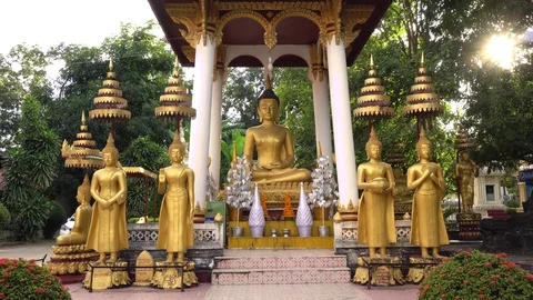 Buddhist statues in temple at sunset Stock Footage 83235581