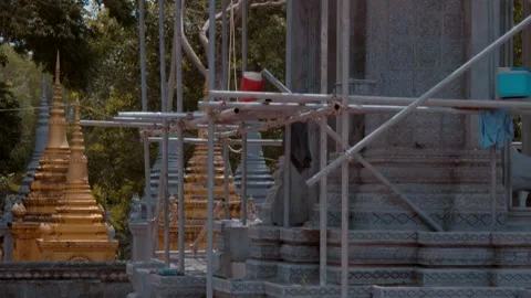 A Buddhist stupa is is being restored constructed with scaffolding  Stock Footage 318681715