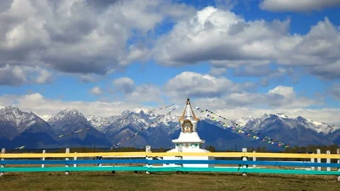 Buddhist stupa with colorful prayer flags in the background of mountains Stock Footage 87542272