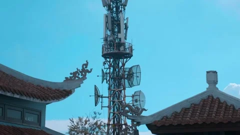 Buddhist Temple and telecommunications tower with antennas Stock Footage 340626642