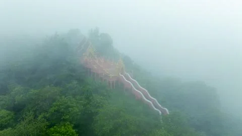 Buddhist Temple Architecture Surrounded By Dense Mist In Lush Mountain Fore.. Stock Photos
