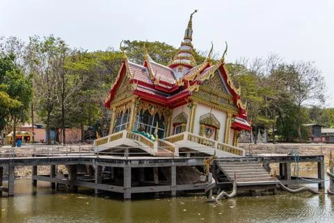 The Buddhist temple fall down inside a concrete construction in water tank Stock Photos