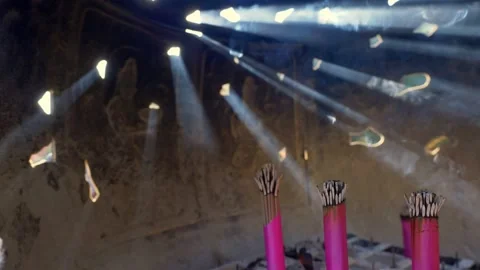 Buddhist temple interior, incense sticks smoke creating sunbeams, magical Stock Footage 224805589