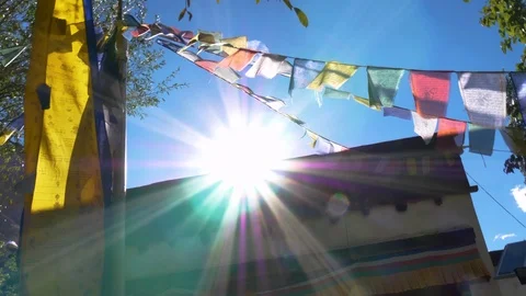 Buddhist temple with prayer flags and sun Stock Footage 127419849