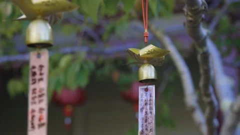 Buddhist wishing bells hanging in a tree Stockbeeldmateriaal 152500706