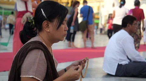 Buddhist Woman Praying at Shwedagon Pagoda, Yangon, Myanmar (Burma) Stock Footage