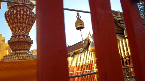 Buddhist write their wish on golden bell ,hang on temple fence in Thailand. Stock Footage 238446730