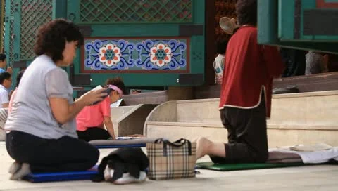 Buddhists bowing down to pray Buddha in temple Stock Footage 11240408