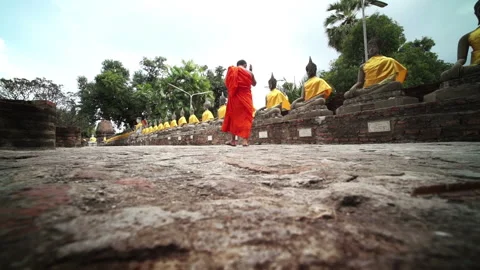 Buddhists walking in a temple Stock Footage 247494301