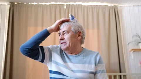 Budgerigar playing with senior man. Budgie. Funny blue purple parakeet sitting Stock Footage 313192524