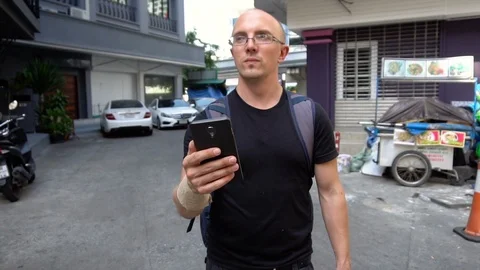 Budget Backpacker Tourist With Smartphone Navigating in Bangkok, Thailand - Stock Footage 105447457