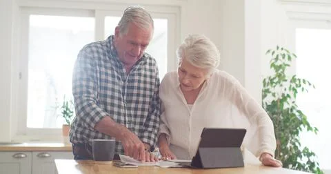 Budget, documents and tablet with old couple in kitchen of home together fo.. Stock Photos