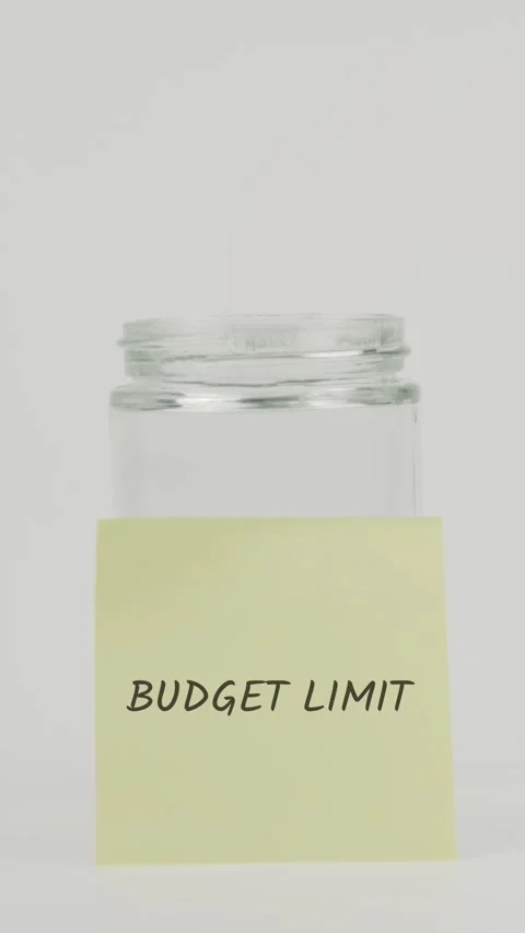 Budget limit text or word on yellow sticky note attached to glass jar Stock Footage 311683804