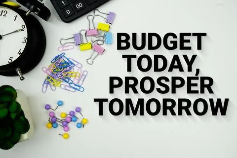 Budget Today, Prosper Tomorrow message with calculator, alarm clock and Sta.. Stock Photos
