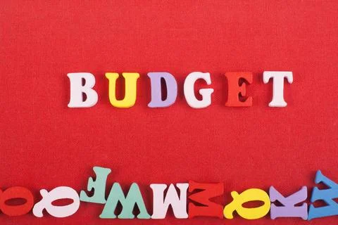 BUDGET word on red background composed from colorful abc alphabet block woo.. Stock Photos